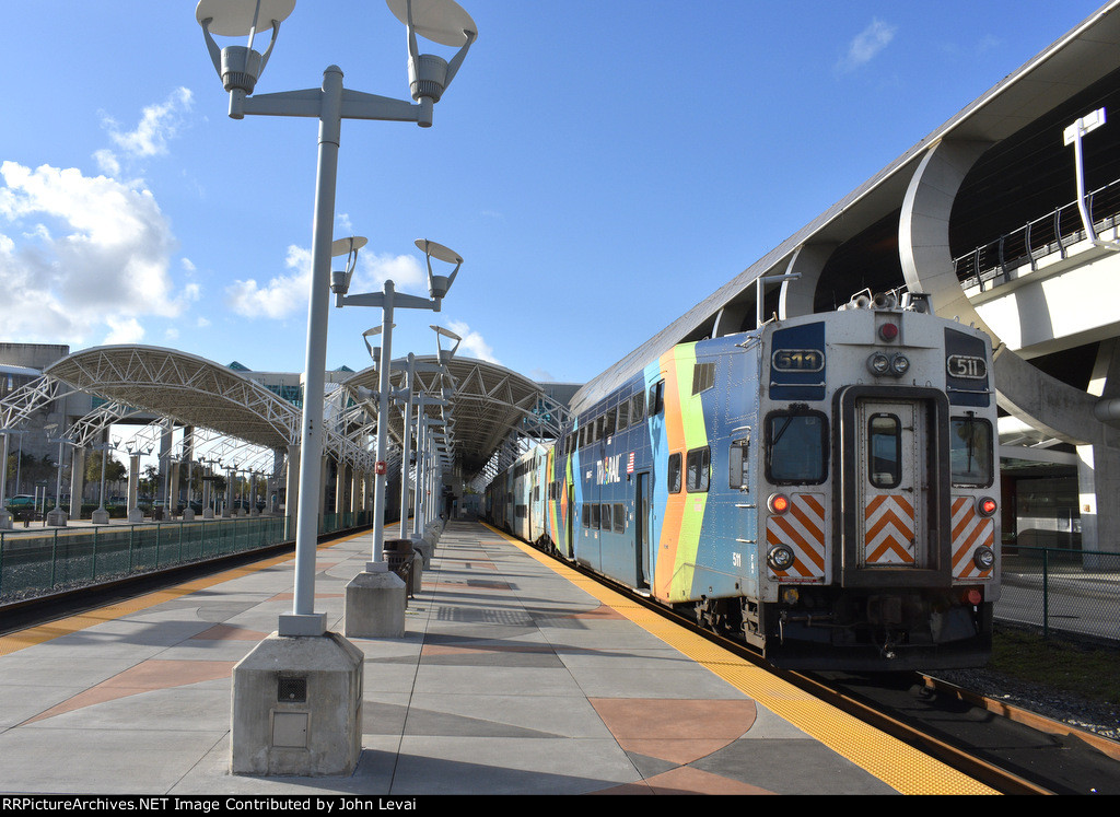 Bombardier Bilevel Cab Car # 511 bringing up the rear of P663 at the MIC. On the left is the Miami Intermodal Center Metrorail Station